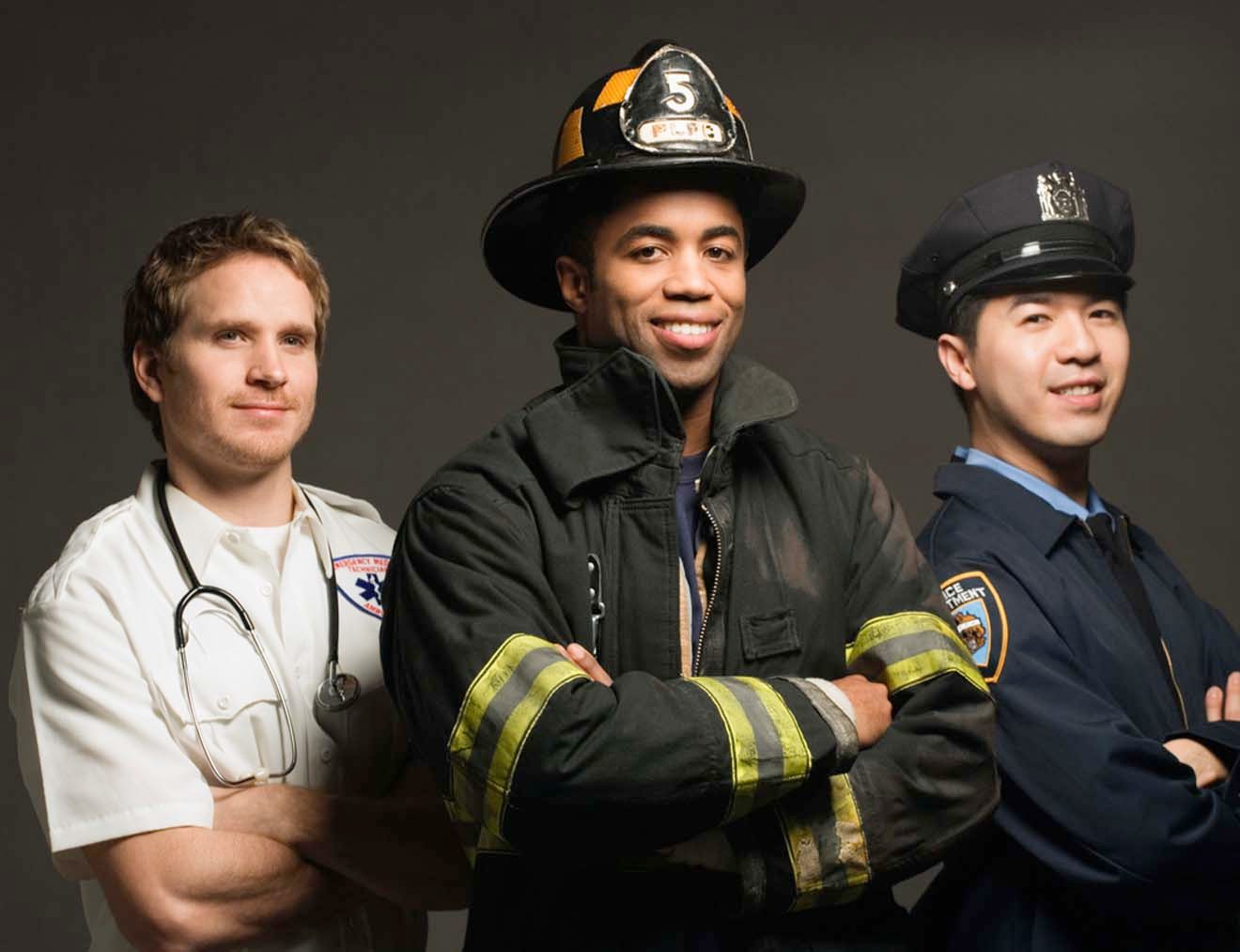 A paramedic, a firefighter and a police officer standing together